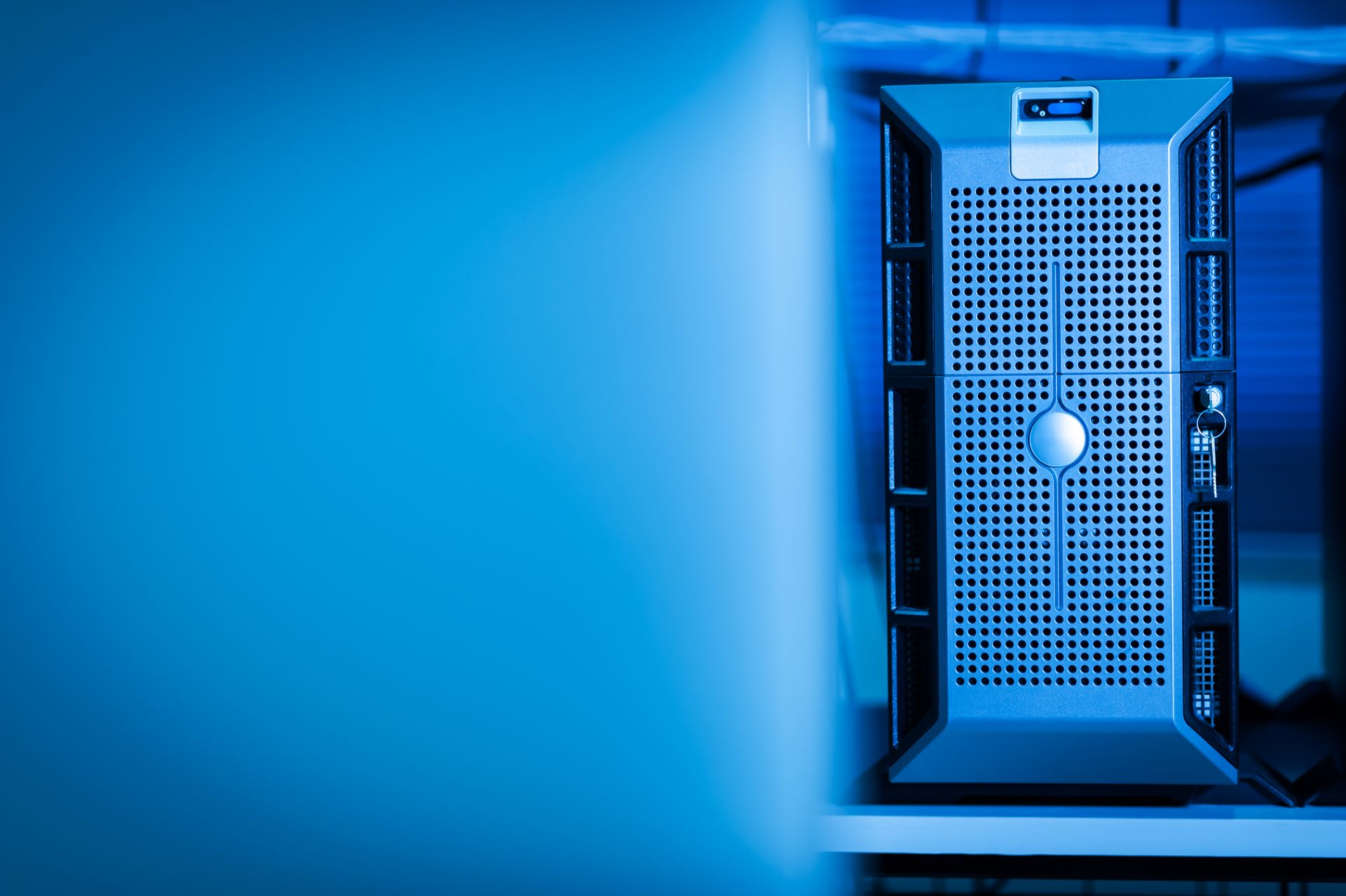 A server tower glowing in a dark room